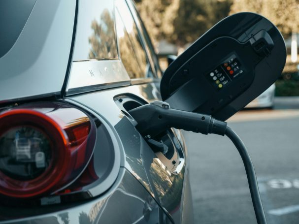 Portable EV charger plugged into electric car during charging process.